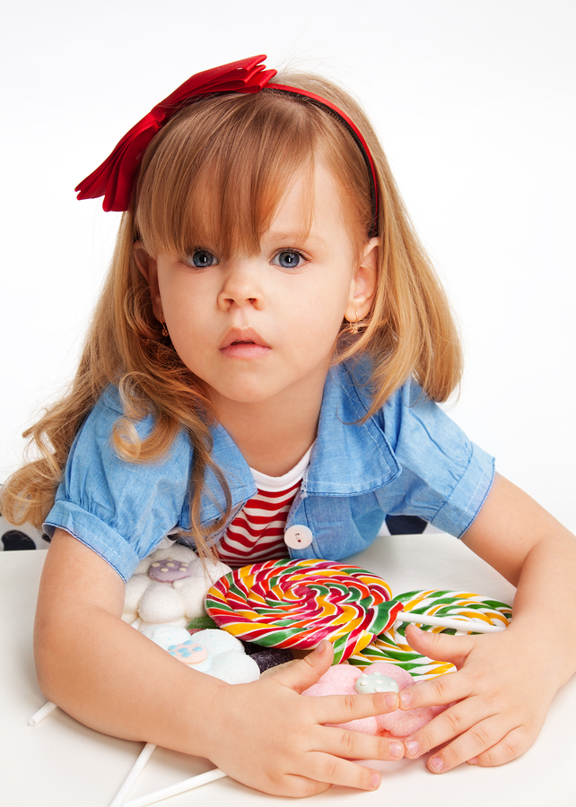 Greedy Girl With Pile Of Candy